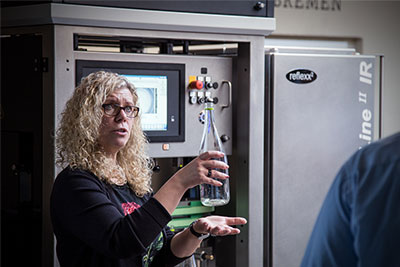 Martina Frey, Product Manager for empty container inspections,demonstrates how the new HEUFT InLine II IR finds foreign objects and other sources of danger in packaging material before the product is filled into the container.